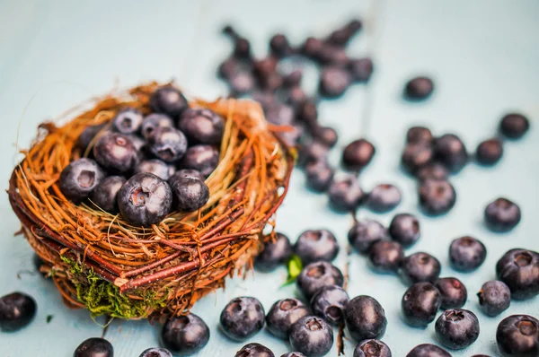 Blueberries in a basket on wooden background — Stock Photo, Image