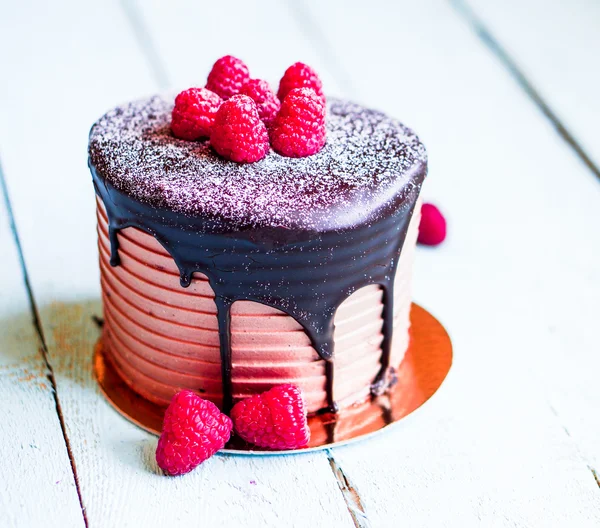 Chocolate cake with raspberries on wooden background — Stock Photo, Image