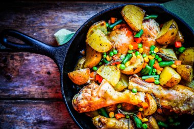 Oven baked chicken with potatoes and vegetables