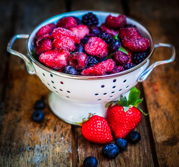 Frozen berries on rustic wooden background — Stock Photo, Image