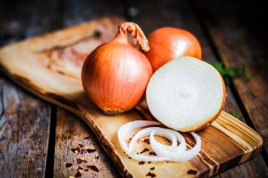 Colorful onions and garlic on rustic wooden background clipart