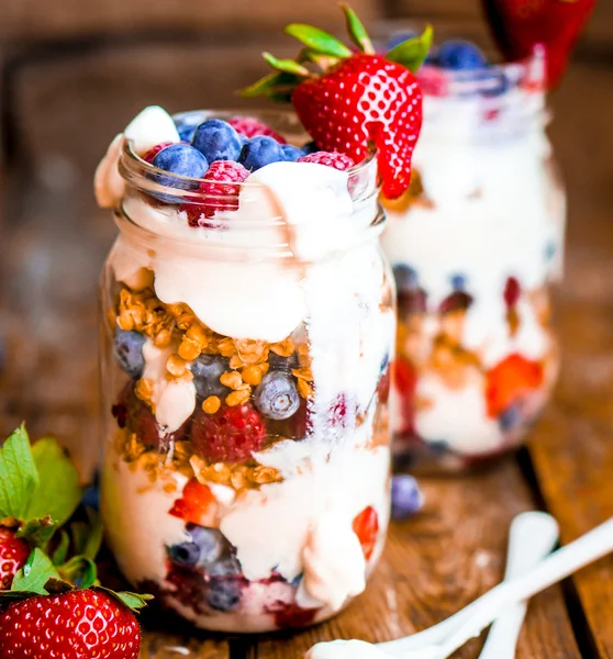 Granola Parfait с йогуртом и ягодами на деревенском фоне — стоковое фото