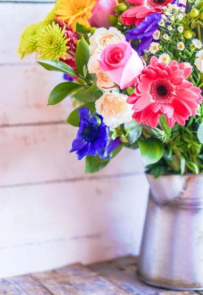 春の花の素朴な木製の背景上にヴィンテージ花瓶のカラフルな花束 — ストック写真