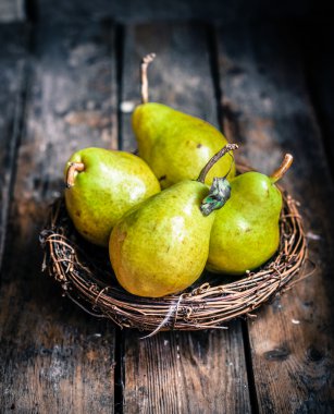 Pears on rustic wooden background clipart
