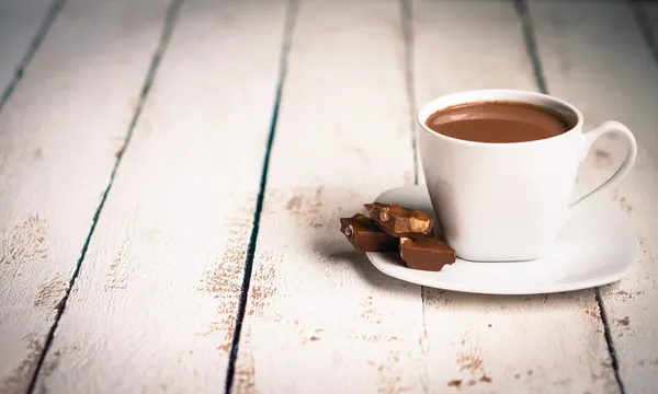 Cup of hot chocolate on wooden background — Stock Photo, Image