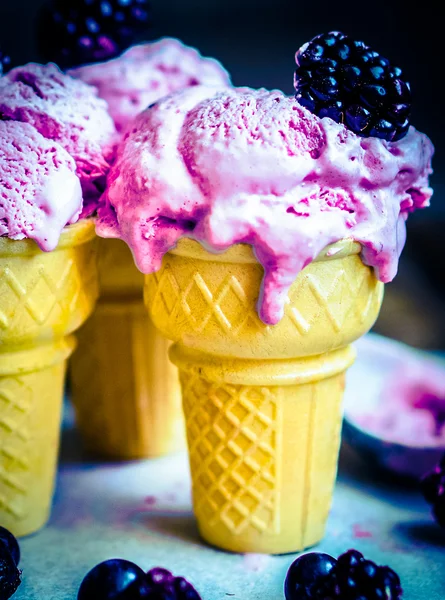 Ice -cream in cones with berries on rustic wooden background — Stock Photo, Image