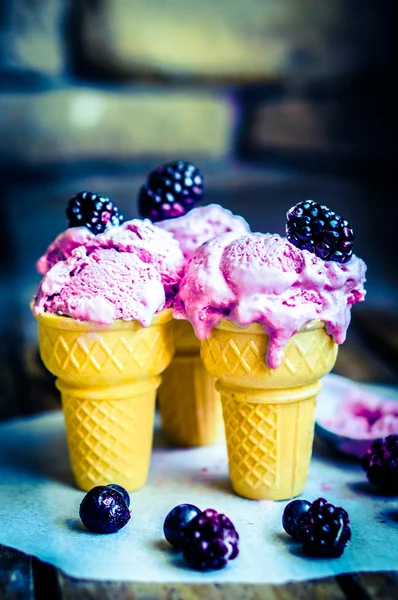 Ice -cream in cones with berries on rustic wooden background — Stock Photo, Image