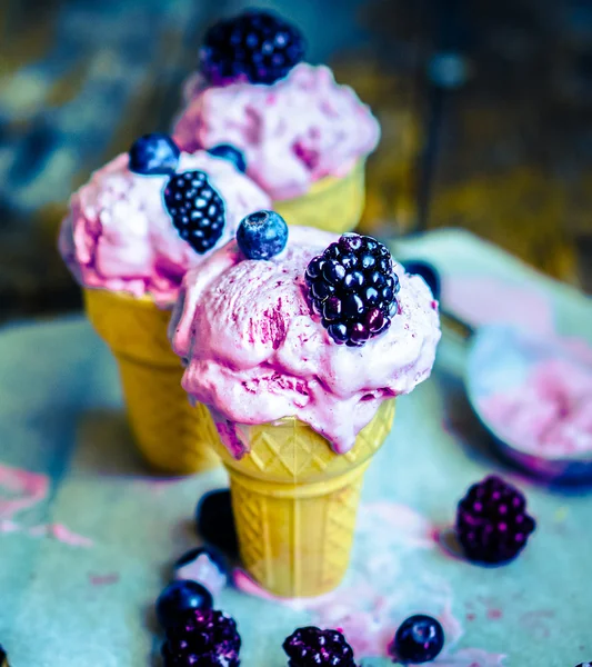 Ice -cream in cones with berries on rustic wooden background — Stock Photo, Image