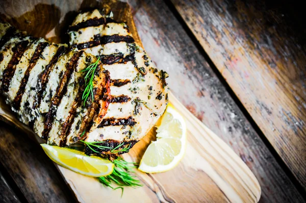 Grilled chicken with potatoes and asparagus on wooden background — Stock Photo, Image