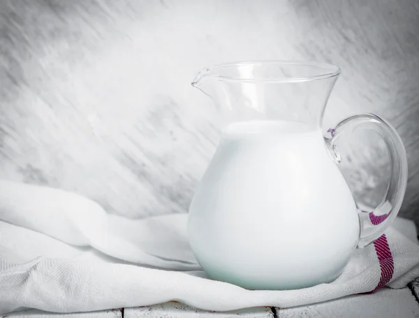 Milk jar on wooden rustic background — Stock Photo, Image