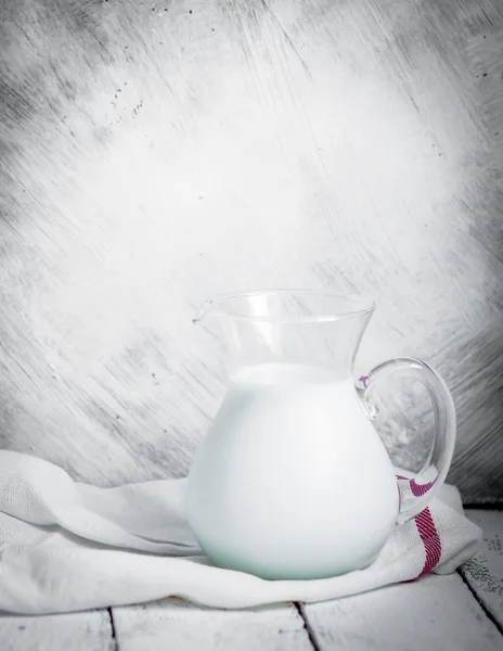 Milk jar on wooden rustic background — Stock Photo, Image