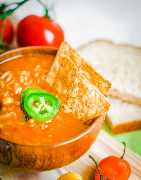 Hot and spicy fresh made Mexican chili soup on rustic background — Stock Photo, Image