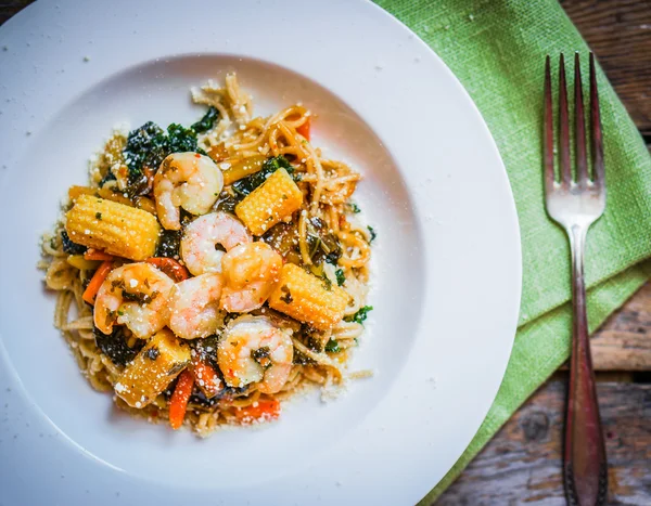 Italienische Pasta mit Garnelen und Gemüse auf Holzgrund — Stockfoto