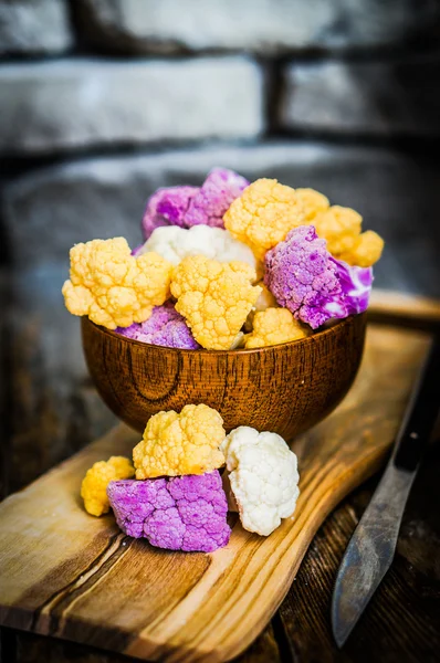 Colorful cauliflower on rustic background — Stock Photo, Image