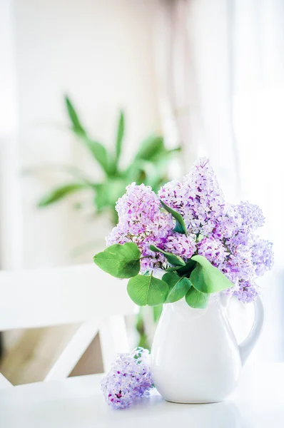 Lilacs in white vase in the kitchen — Stock Photo, Image