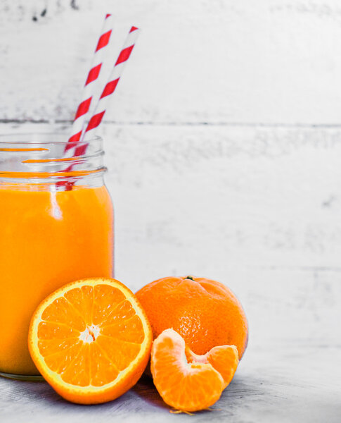 Orange smoothie on rustic background