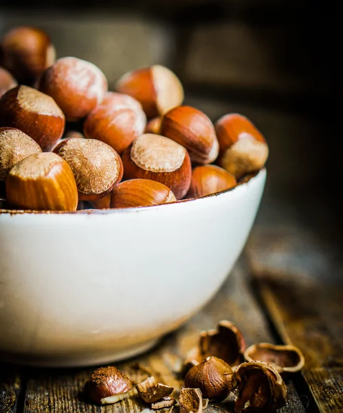 Hazelnuts on rustic wooden background — Stock Photo, Image