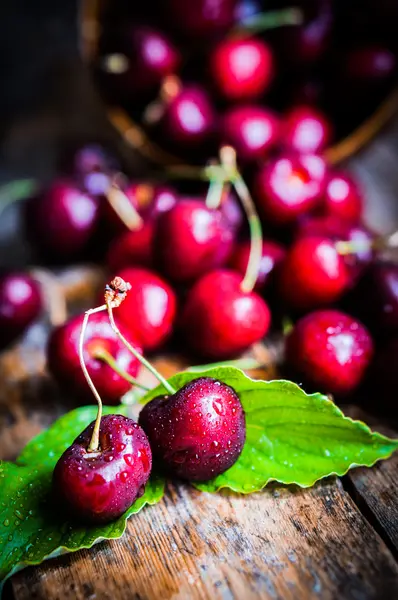 Cherries on rustic wooden background — Stock Photo, Image