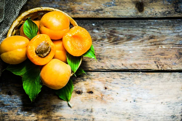 Apricots on rustic wooden background — Stock Photo, Image