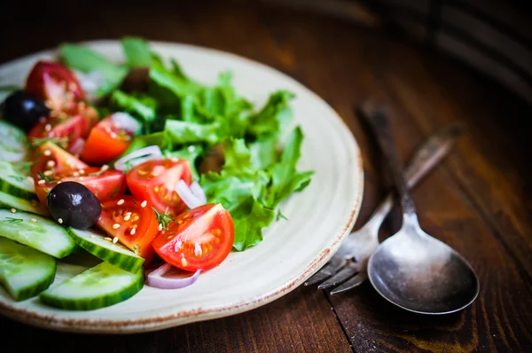 Vegetable salad on wooden background — Stock Photo, Image