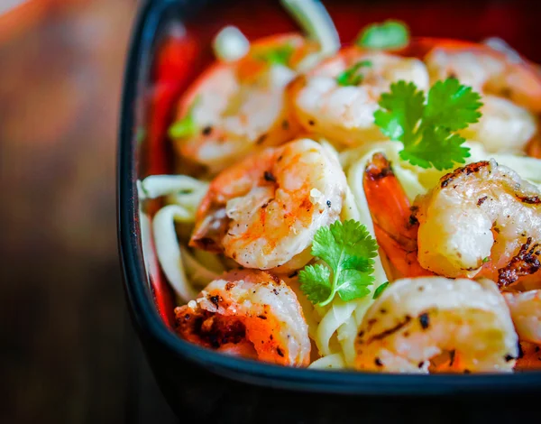 Pasta mit gegrillten Garnelen auf hölzernem Hintergrund — Stockfoto