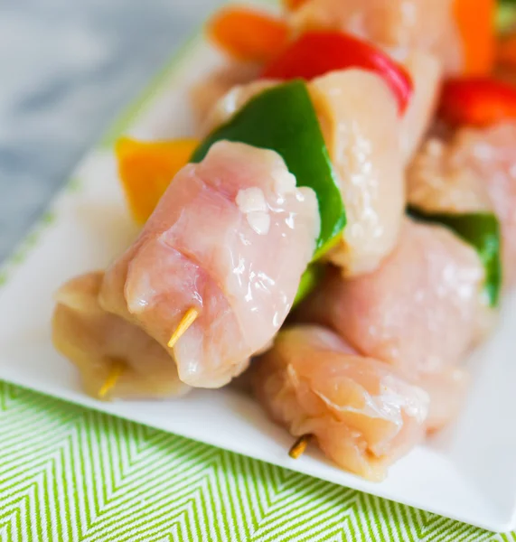 Raw chicken kebabs with baked potatoes — Stock Photo, Image