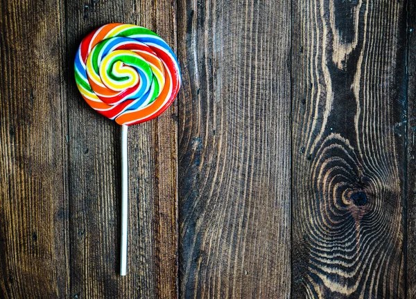 Lollipop on wooden background — Stock Photo, Image