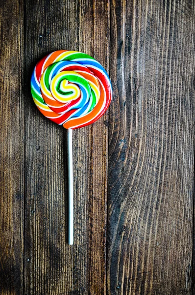 Lollipop on wooden background — Stock Photo, Image