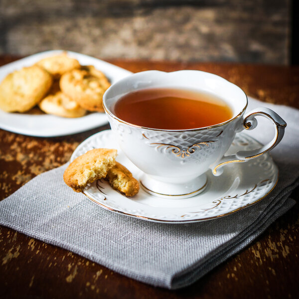 Tea with cookies on wooden background