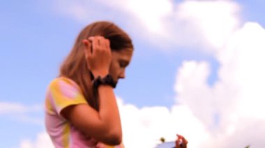 The girl, the teenager plays, works with a tablet, iPad
