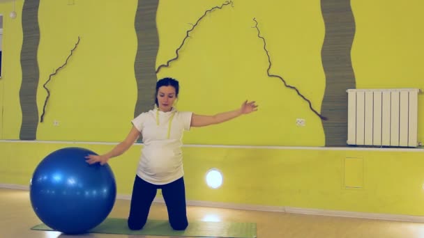 En gravid kvinna gör övningar med bollen, yoga — Stockvideo