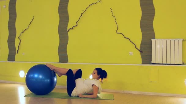 Een zwangere vrouw doen oefeningen met de bal, yoga — Stockvideo