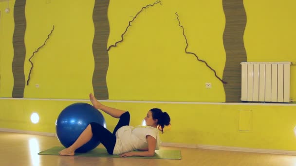 Вагітна жінка робить вправи з м'ячем, йога — стокове відео
