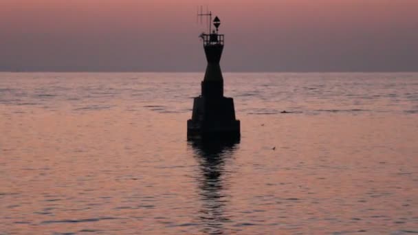 Sunrise at sea with waves and indicator buoy — Stock Video