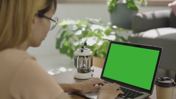 机の上のPcのオフィスのインテリアで働くビジネス女性の肩のショットの上に 緑の画面を見てください ノートパソコンの緑の画面でノートパソコンを使用しているオフィスの人 — ストック動画