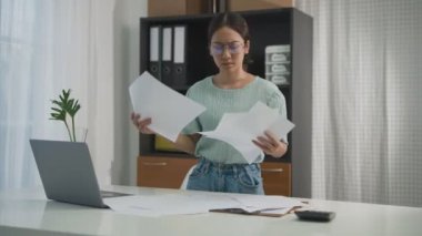 Asian woman feeling stress from work in the office.Tired business woman at workplace in office holding her head on hands feel headache.