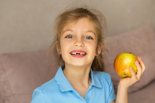 Beautiful little girl lost the first milk tooth. Happy child dropped the first milk tooth. Stock Photo