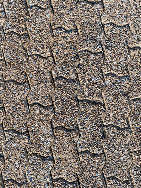Close up of the brown rough brick pavement background