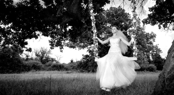 Bride on swing on green glade