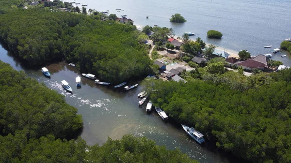 Aerial view of the mangrove forest on Junggut Batu, Nusa Lembongan. There are several fisherman's houses around there. White sand beach with pristine seawater. Mangroves look thick and healthy