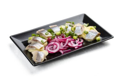 Hafif tuzlanmış ringa balığı, haşlanmış patates ve soğanlı aperatif. Beyaz bir arkaplanda izole edilmiş