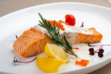 Sos soslu somon filetosu ve kırmızı havyar, biberiye ve limon..