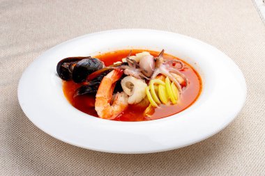 Traditional Marseille Bouillabaisse fish soup with prawns, mussels tomato,lobster, squid.