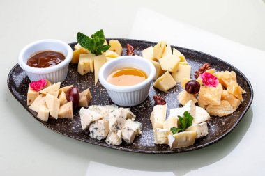 A plate with a variety of cheeses.