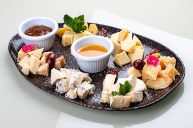 A plate with a variety of cheeses.