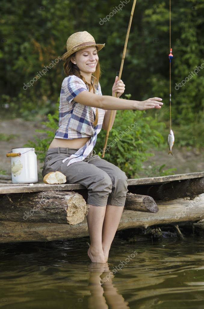 Beautifull girl fishing on the pier — Stock Photo © Chernik26 #28277815