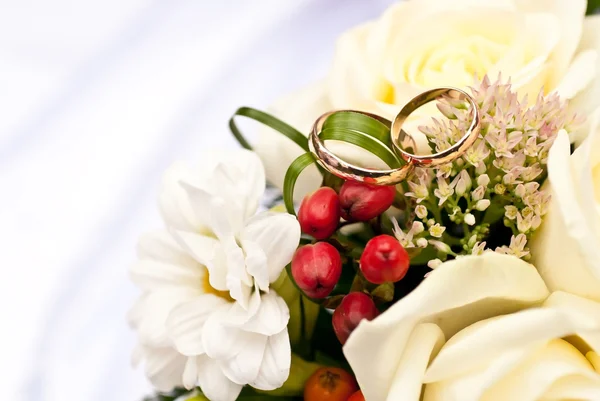 Wedding rings and flowers Stock Photo