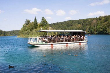 Plitvice Lakes Ulusal Parkı, Hırvatistan - 9 Eylül 2012: Hırvatistan 'daki Plitvice Gölleri Ulusal Parkı' nda bir turistik tekne. Ulusal park 1949 yılında kurulmuş ve orta Hırvatistan 'ın dağlık karst bölgesinde yer almaktadır. Dünyaca ünlü.