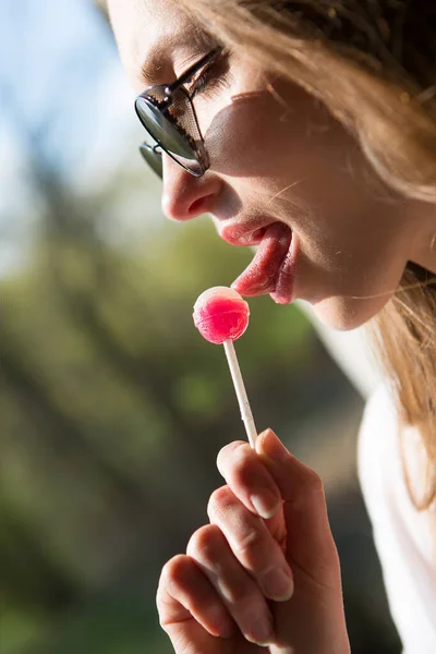 Beautiful Young Woman Sucking Lollipop — стоковое фото