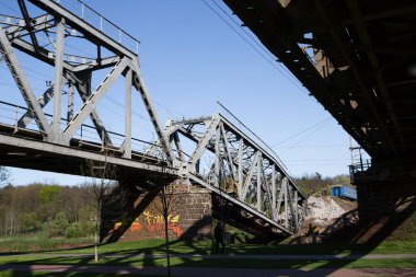 Irpen, Kyiv region - May 5, 2022: Railroad bridge destroyed by bombs. War between Russia and Ukraine, May 5, 2022. clipart